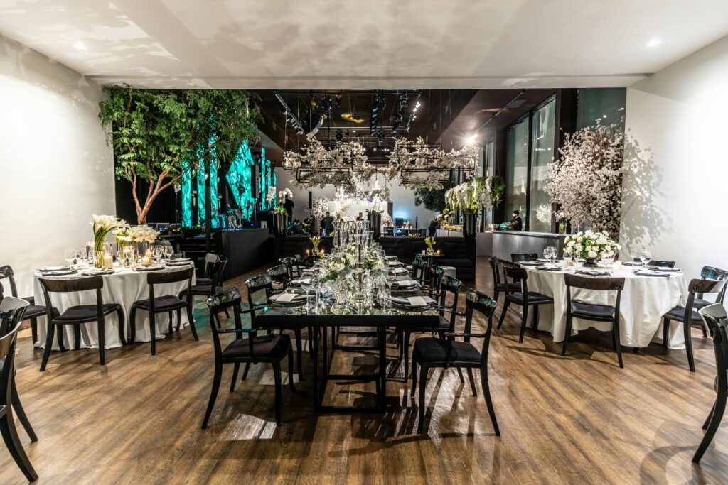 Luxurious wedding venue with floral arrangements and elegant table settings.